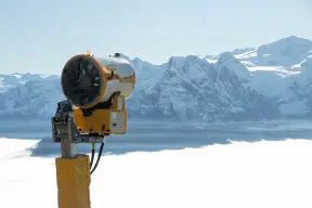 Snow gun above cloud-filled valley